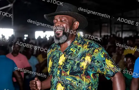 Happy Elderly Man Dancing Joyfully At Community Gathering In Colorful Shirt Surrounded By Laughing Friends