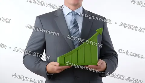 Businessman Holding Green Bar Chart Representing Positive Financial Growth In Corporate Environment