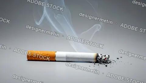 Smoking Cigarette Releasing Gray Smoke On Plain Surface Representing Addiction Danger And Environmental Pollution