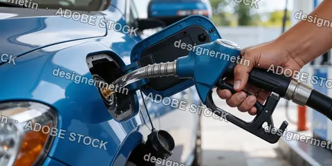 Close-Up View Of Hand Refueling A Car With Gasoline At Gas Station During Daylight Hours