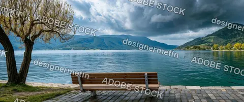 Wooden Bench Overlooking Turquoise Alpine Lake With Green Mountains And Dramatic Stormy Clouds In Peaceful Nature Landscape