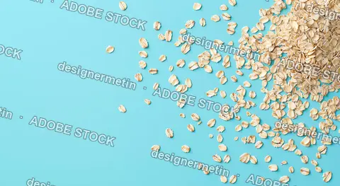 Healthy Raw Rolled Oats Flakes Scattered On A Blue Background With Copy Space For Breakfast Food Design
