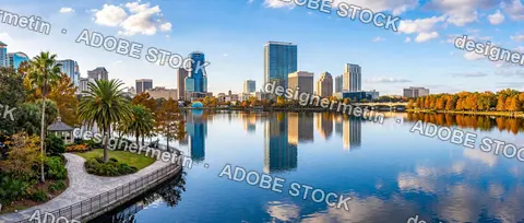 Orlando City Skyline Reflected In Calm Lake Eola With Palm Trees And Waterfront Promenade Florida