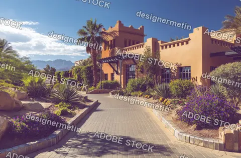 Desert Resort Building With Palm Trees And Landscaped Pathway View    