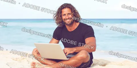 Smiling Man Using Laptop On Sandy Beach