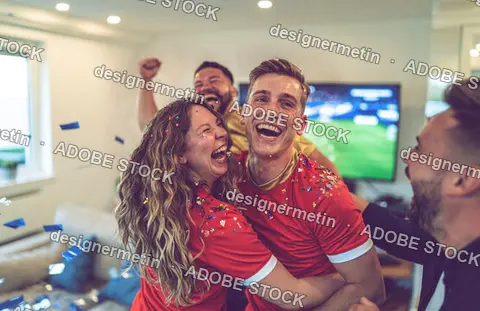 Diverse Friends Celebrating Soccer Match Victory While Watching Television