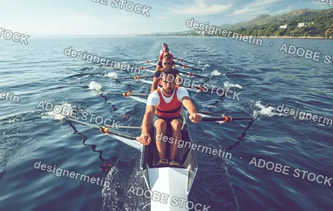 Synchronized Rowing Team Paddling Racing Shell Across Calm Coastal Water