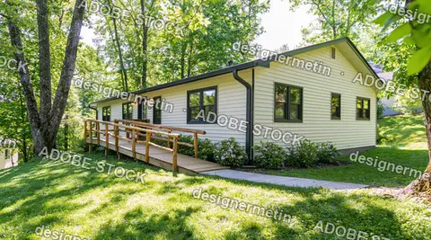 Single Story Suburban Home With Wheelchair Ramp Surrounded