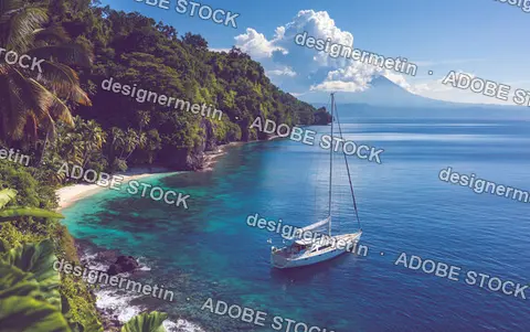 White Sailboat Anchored In A Tropical Turquoise Cove With Lush Green Mountains