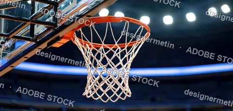 Close Up View Of A Basketball Hoop With White Netting Against A Dark Court Background