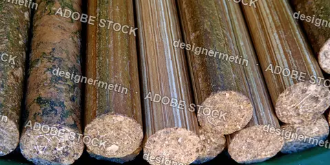 Compressed Wood Pellets And Biomass Briquettes Arranged Closely Together In A Neat Row
