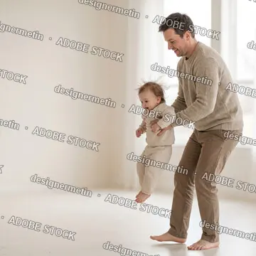Happy Father Playing With His Joyful Baby In A Bright White Room, Lifting The Toddler Up In The Air With Love And Laughter